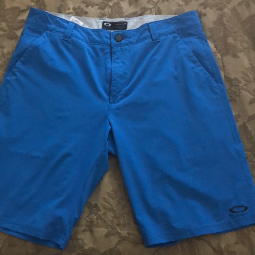 Blue Oakley flat front shorts.